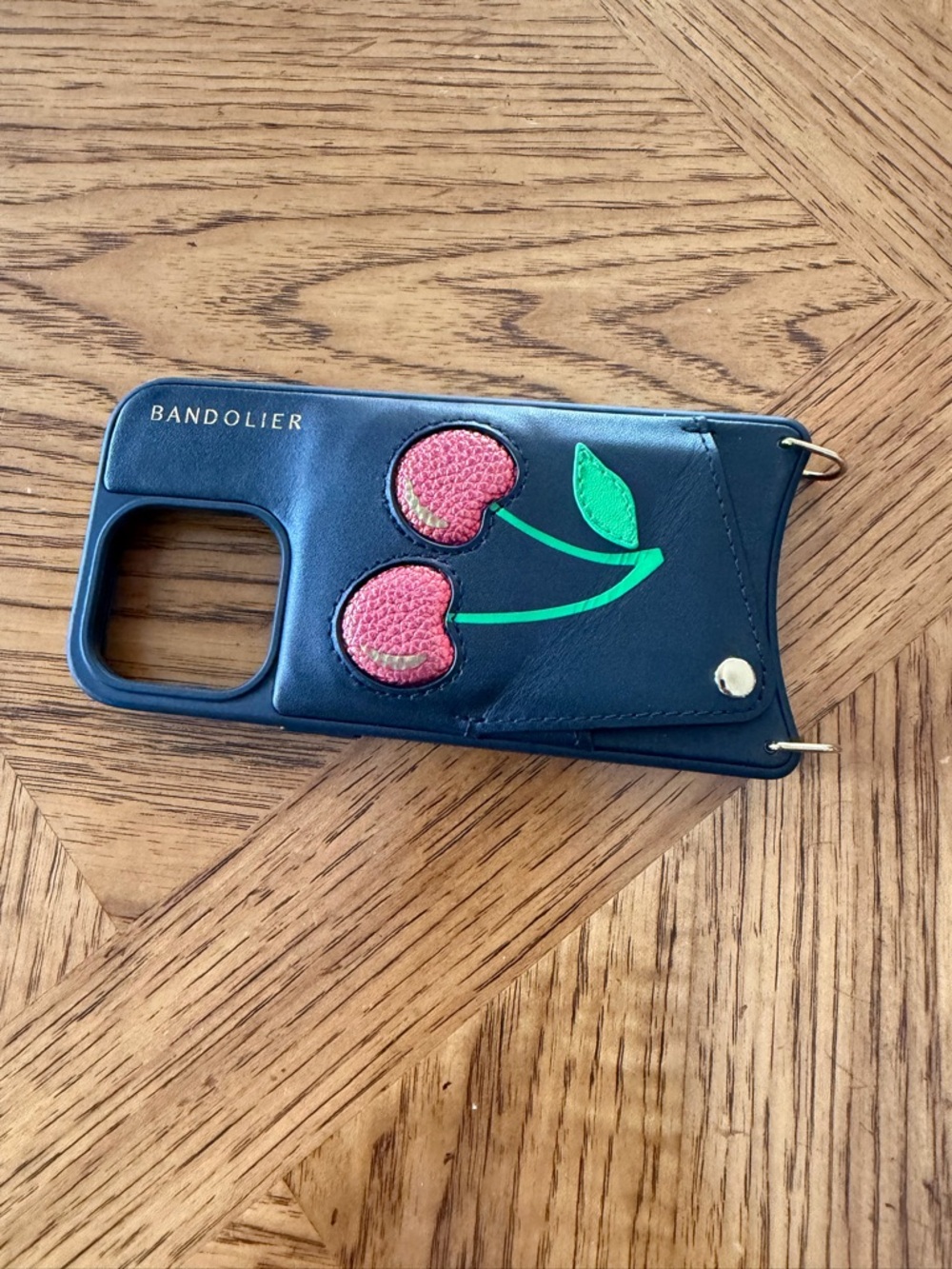 Bandolier Navy iPhone 14 Pro Case with a red metallic Cherry Patch